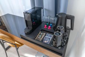 a counter with a coffee maker on a table at Villa Vaicun - Boutique Rooms in Lörrach