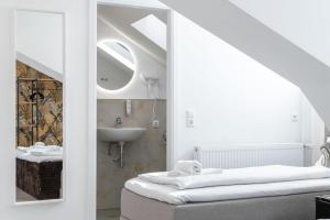 a bathroom with a sink and a mirror at Villa Vaicun - Boutique Rooms in Lörrach