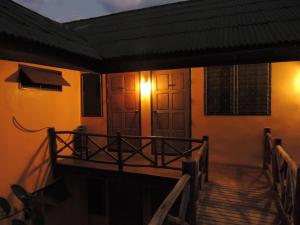 a house with a balcony with a light on it at Khunyuam Resort in Ban Khun Yuam