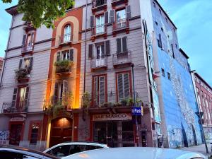 a building on a street with cars parked in front of it at UrbanSuite Torino in Turin