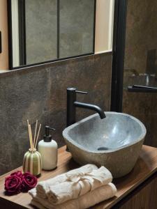 a bathroom with a bowl sink on a counter at UrbanSuite Torino in Turin +19 photos