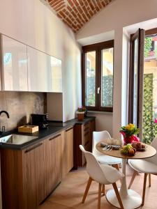 a kitchen with a table and chairs and a counter at UrbanSuite Torino in Turin