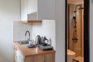 a kitchen with a sink and a coffee maker on a counter at Sunny Vibes by Estia Adults Only in Stalís