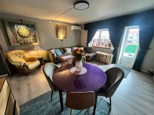 a living room with a purple table and chairs at Trolladalen-Sogndal in Sogndal