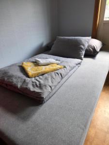 a bed with two towels on top of it at Rom 4 i bufellesskap in Sogndal