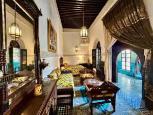a large living room with a couch and a table at Riad Fes Baraka Piscine & SPA in Fez