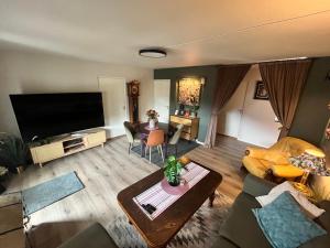 a living room with a large flat screen tv at Trolladalen-Sogndal in Sogndal