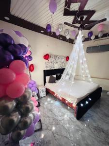 a room with a bed with a bunch of balloons at m m residency in New Delhi