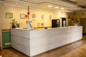 a counter in a store with clocks on the wall at Nova Vicenza Hotel in Farroupilha