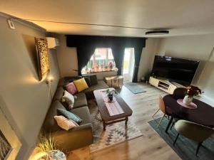 a living room with a couch and a table at Trolladalen-Sogndal in Sogndal