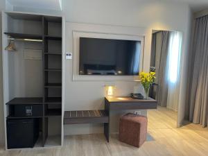 a room with a desk and a tv on a wall at Hotel Serafino in Padova +19 photos