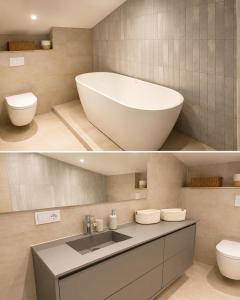 a bathroom with a tub and a toilet and a sink at Villa Mave - Cascais in Estoril +21 photos