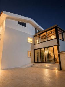 a large white house with large windows at night at Villa Mave - Cascais in Estoril