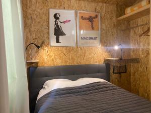 a bedroom with a bed and posters on the wall at La Cabane des Bains in Marciac