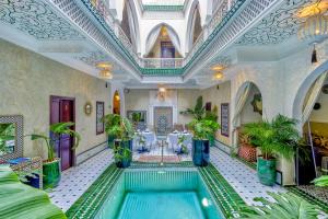 an indoor pool in a building with a ceiling at Riad Samir Oasis And Spa in Marrakesh +6 photos
