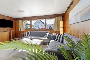 a living room with two couches and a tv at Klassische Motoryacht Ocean Motion in Flensburg