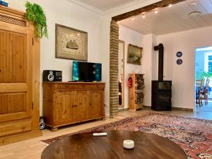 a living room with a table and a tv at Große Kutscherwohnung in Kiel +22 photos