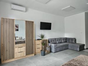 a living room with a couch and a television at Penzión ANTRACIT in Štúrovo