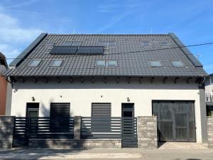 a house with solar panels on the roof at Penzión ANTRACIT in Štúrovo