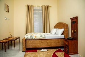 a bedroom with a wicker bed and a window at Angel homestay hotel in Mikumi +54 photos