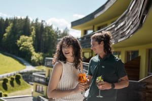 a man and a woman standing in front of a house at DAS SIEBEN - Adults Only in Bad Häring