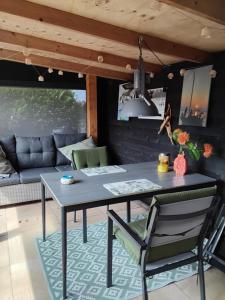 a table and chairs in a living room with a couch at Weerribben Wieden gastenverblijf in Wanneperveen