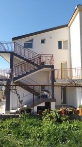 a apartment building with a staircase in front of it at Apartmani Rubi 2 in Herceg-Novi