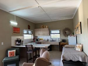 a kitchen with a table and chairs and a refrigerator at Karibu Self-Catering unit 2 in Omaruru