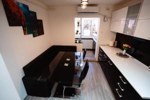 a kitchen with a black dining table in a room at Danube Breeze Apartment in Giurgiu +14 photos