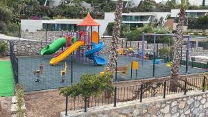 a playground with a slide and a play structure at Beachfront Villa with private beach and pool in Bogazici