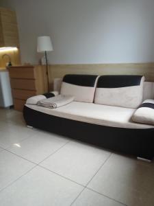 a black and white bed in a room at Apartament 112 Mielno in Mielno