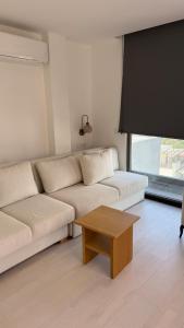 a living room with a couch and a coffee table at Beachfront Villa with private beach and pool in Bogazici +30 photos