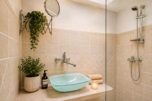 a bathroom with a sink and a glass shower at SalentoTraTerraMare in Diso +20 photos