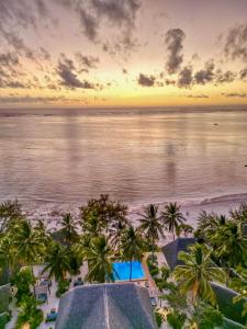 an aerial view of a beach with palm trees and the ocean at Mnana Beach Bungalows in Michamvi +55 photos
