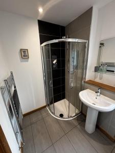 a bathroom with a shower and a sink at Achnacolain Lodge in Tarbert +9 photos