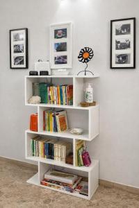 a white book shelf filled with books in a room at B&B Residence Armonia Sulmona in Sulmona