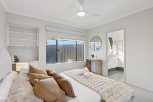 a living room with a couch and a large window at The Aveley Retreat in The Vines