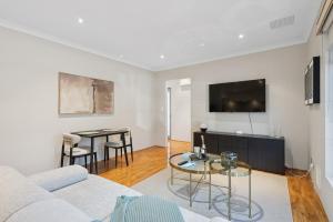 a living room with a couch and a table at The Aveley Retreat in The Vines