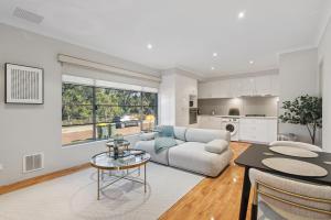 a living room with a couch and a table at The Aveley Retreat in The Vines