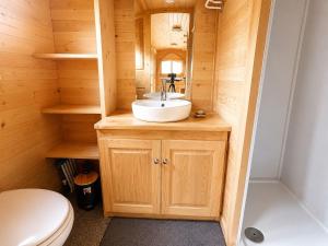a small bathroom with a sink and a toilet at Blue : La Roulotte du Médoc in Naujac-sur-Mer +21 photos