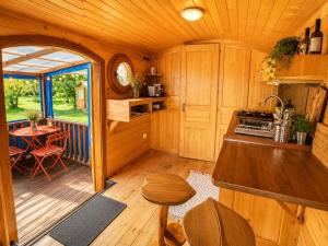 a kitchen and dining area of a tiny house at Blue : La Roulotte du Médoc in Naujac-sur-Mer