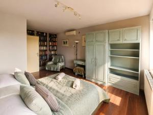 a bedroom with a bed and a desk in it at Sefira Homes G in Keszthely