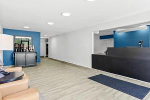 a lobby with a reception desk and a counter at Suburban Studios Copley Akron West in Copley