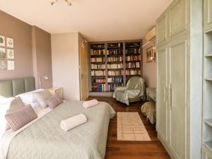 a bedroom with a bed with two pillows on it at Sefira Homes G in Keszthely