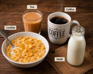 a table with a bowl of cereal and a cup of milk at Urben BellaMount Hotel - Free Airport and Aerocity Pick Up & Drop in New Delhi