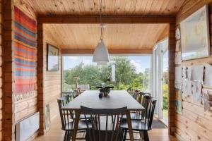 a dining room with a table and chairs at 1693-Kikhavn-Kragevejen-3 in Kikhavn +13 photos
