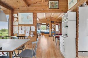 a room with wooden ceilings and a table and chairs at 1693-Kikhavn-Kragevejen-3 in Kikhavn