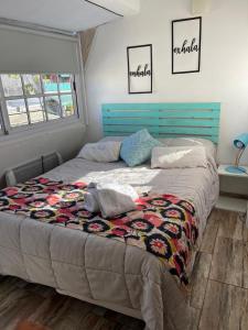 a bed with a blue headboard in a bedroom at Arenales 2111 Recoleta in Buenos Aires