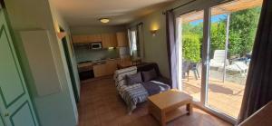 a living room with a couch and a table at maison de vacances in Tourrettes