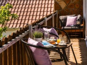 a patio with a table and chairs on a balcony at Sefira Homes G in Keszthely